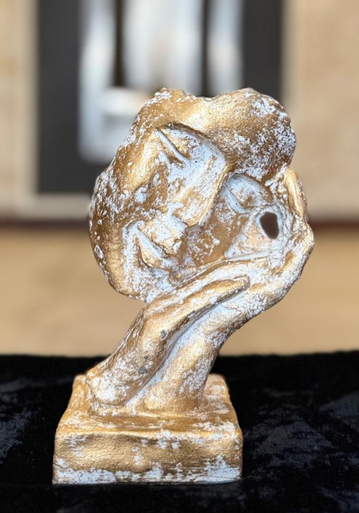 Hand Holding Heart Sculpture