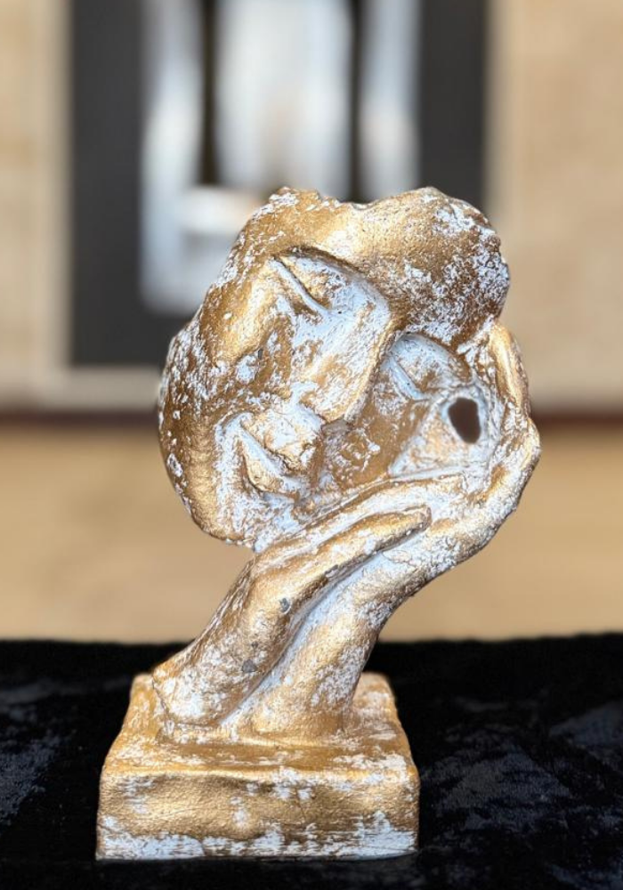 Hand Holding Heart Sculpture